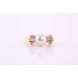 A pearl and diamond ring, the cultured pearl flanked by three baguette diamonds to either side, in