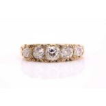 Five stone diamond ring, the graduated old European cut diamonds claw set to a scrollwork gallery,