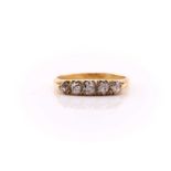 A five stone half hoop diamond ring; the graduated old brilliant cut diamonds in carved and
