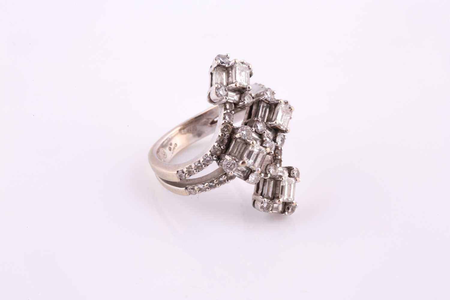 A diamond dress ring Of bifurcated design, obliquely-set to the front with four clusters of baguette - Image 4 of 6