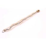 A three-row cultured pearl bracelet, consisting of two outer knotted and slightly graduating rows of