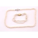 A cultured pearl necklace, the uniform pearls approximately 7 mm diameter, the white metal