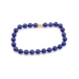 A lapis lazuli bead necklace, consisting of twenty-five round polished lapis lazuli beads