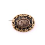 Victorian ‘In Memory Of’ brooch, mid 19th century, black enamel ground with scrollwork outer border,