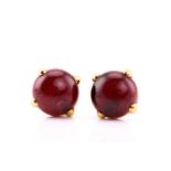 A pair of Pomellato “Griffe" earrings, each consisting of a round red garnet hollow cabochon,