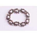 Georg Jensen - an oval cabochon and scroll bracelet, No.10, silver import marks for 1977, 18.5cms