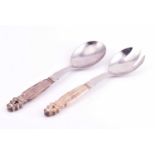 A pair of Georg Jensen stainless steel and "Sterling" silver salad servers in the acorn pattern, 5.4