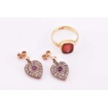 A pair of diamond and ruby heart-shaped earrings, pave-set with mixed-cut diamonds, in silver and