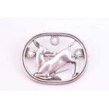 Georg Jensen - a brooch depicting kneeling deer and flowers, designed by Arno Malinowski, No.256,