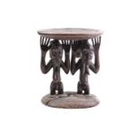 A large Hemba stool, Democratic Republic of Congo, the slightly dished top supported by a