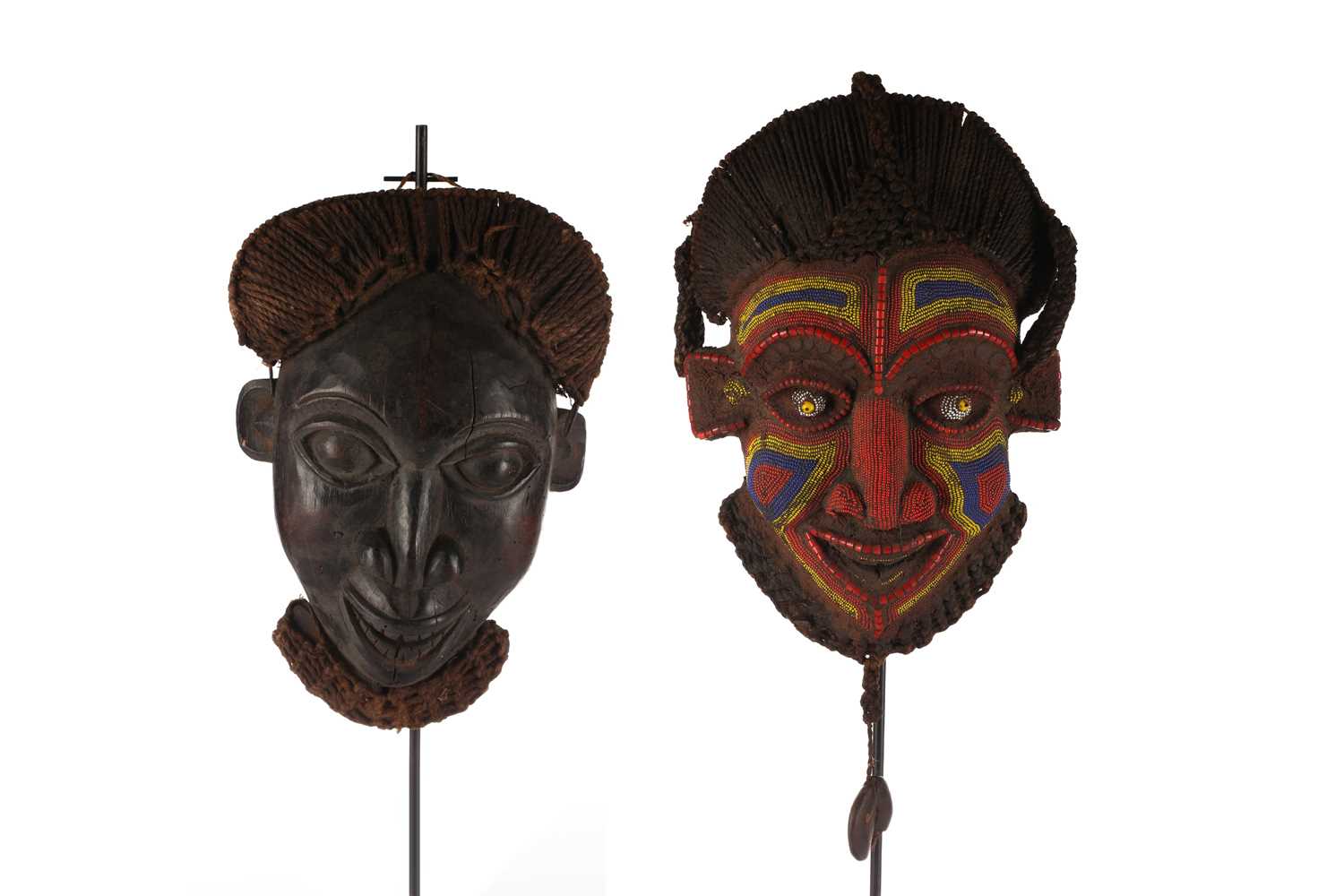 A Bamun beaded face mask, Cameroon, with woven raffia coiffure and beard, a long braid issuing