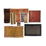 A collection of 12 African, Indonesian, and Indian textiles, including Ghanian wax print, each