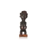 A large Luba female figure with divination bowl, Democratic Republic of Congo, the kneeling female