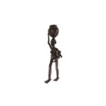 A large Nigerian bronze standing figure of a mother and child, supporting a large simulated woven