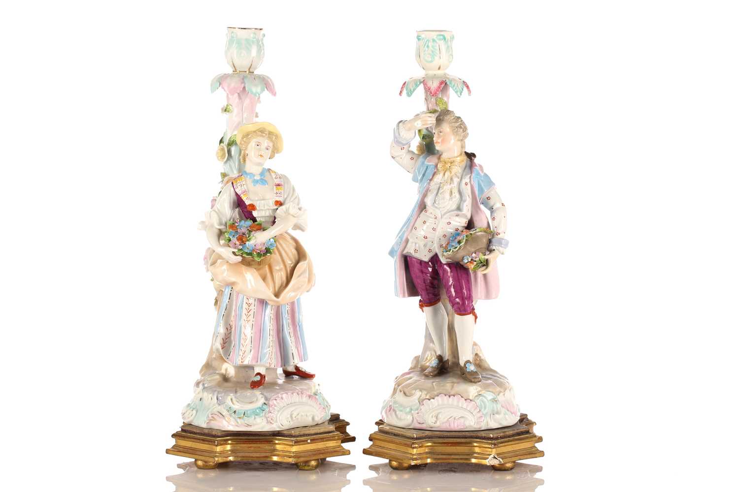 A pair of Continental porcelain figural candlesticks, late 19th century, possibly Volkstedt, mounted
