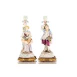 A pair of Continental porcelain figural candlesticks, late 19th century, possibly Volkstedt, mounted