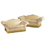 A pair of Harrods camel back two-seat sofas with stuff over pale gold Damask upholstery with