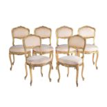 A set of six Louis XV style carved wood and gilt gesso salon chairs, early 20th century, with floral