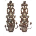A pair of carved and gilt Italianate Baroque three branch wall sconce with hanging fruit satyrs mask