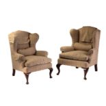 A close pair of George III style wingback fireside armchairs, early 20th century with cream plaid