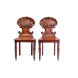 A pair of George IV mahogany shell backed hall chairs, possibly by Gillows of Lancaster, Each with