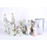 A collection of Lladro and Requena porcelain figures, to include two lovers eating grapes before a