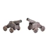 A pair of ornamental cast-iron miniature signal canons on wheeled carriages. 54 cm long x 30