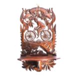 A carved wood folding wall hanging shelf height 62cm, width 34.5cm, in the form of a man on a