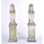 A pair of cast stone figures of standing heraldic lions each holding a shield with "lion rampant"