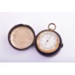 A brass compensated pocket barometer and compass ; silvered circular dial; in original leather-bound