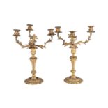 A pair of gilt metal three branch candelabra, late 19th/early 20th century, in the rococo style with
