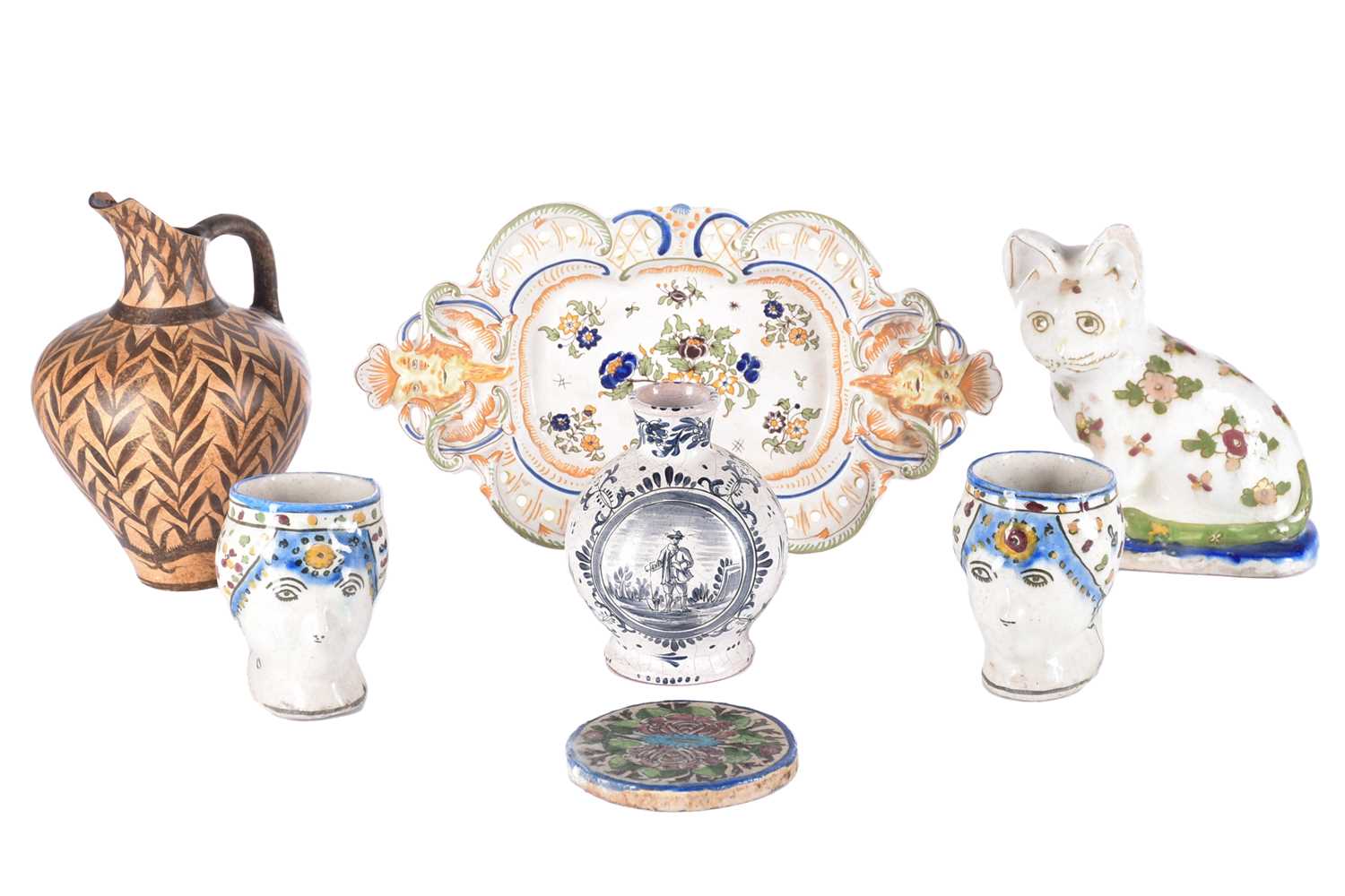 A collection of seven items of continental ceramics including a delftware vase, faience ware cat,