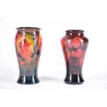 A 20th Century Moorcroft flambe wisteria vase and a Moorcroft flambe leaf & berries vase, both