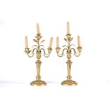 A pair of gilt matel three branch candelabra, late 19th/arly 20th century, the branches