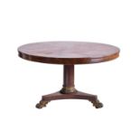 An early 19th century figured rosewood breakfast table, the tilt top with a running band of stylized