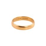 A 22ct yellow gold wedding band, comprises a plain D-section ring with Birmingham hallmarks and