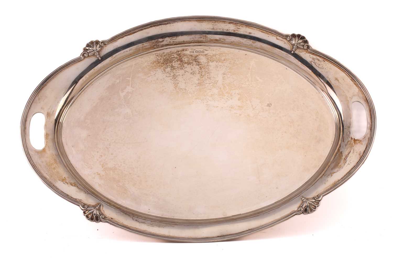 An early 20th-century heavy gauge silver two-handed oval tray. Sheffield 1932 by Walker & Hall. With