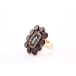 A 19th century mourning brooch converted into a ring, with a central agate cameo surrounded by a
