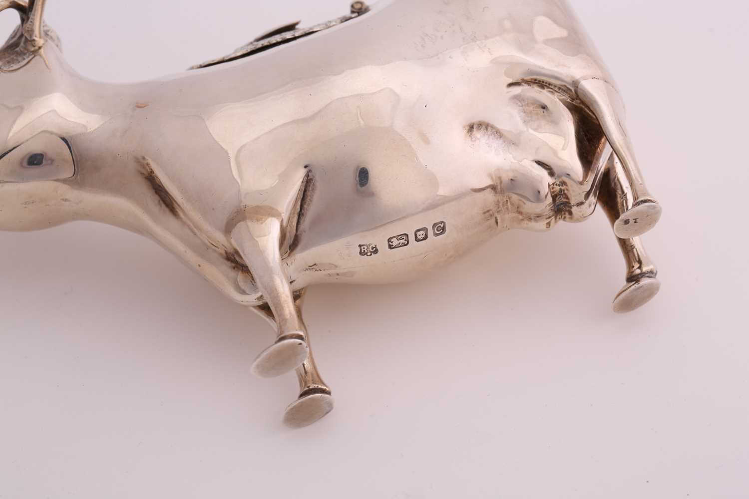 A 20th century silver cow creamer; of traditional form, the hinged cover with an applied bee. London - Image 3 of 4