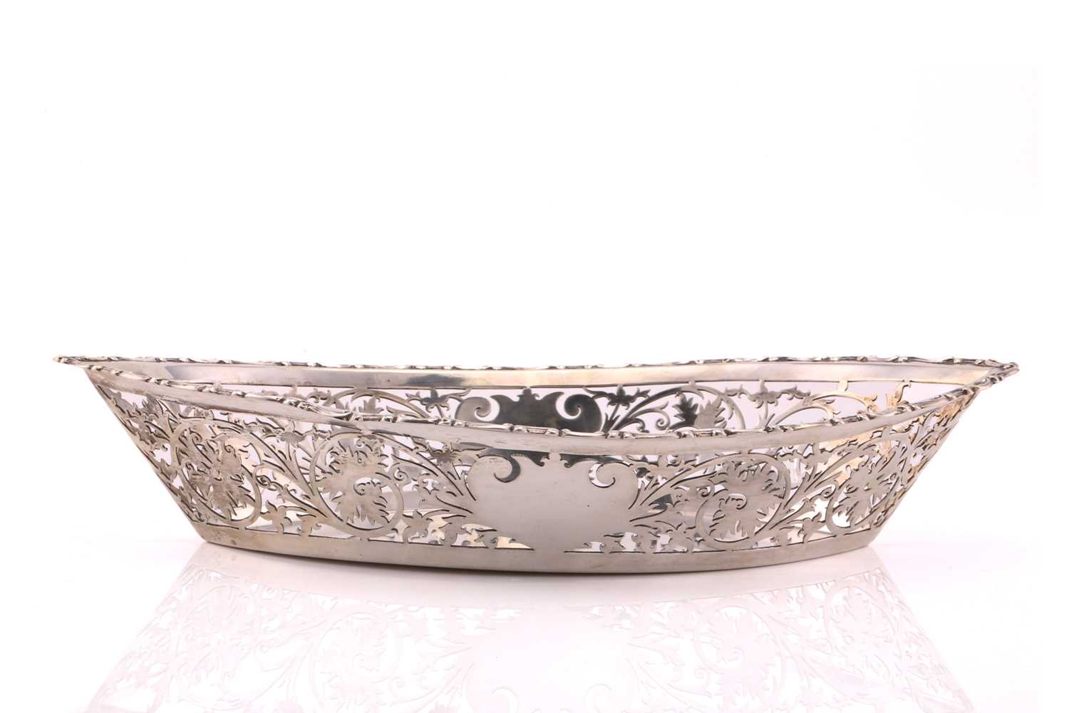 An Edwardian navette form pierced silver breadbasket. Chester 1902 by William Neale. With cast and - Image 2 of 4