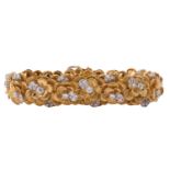 A Kutchinsky platinum and 18ct yellow gold diamond bracelet, comprises articulated links in form