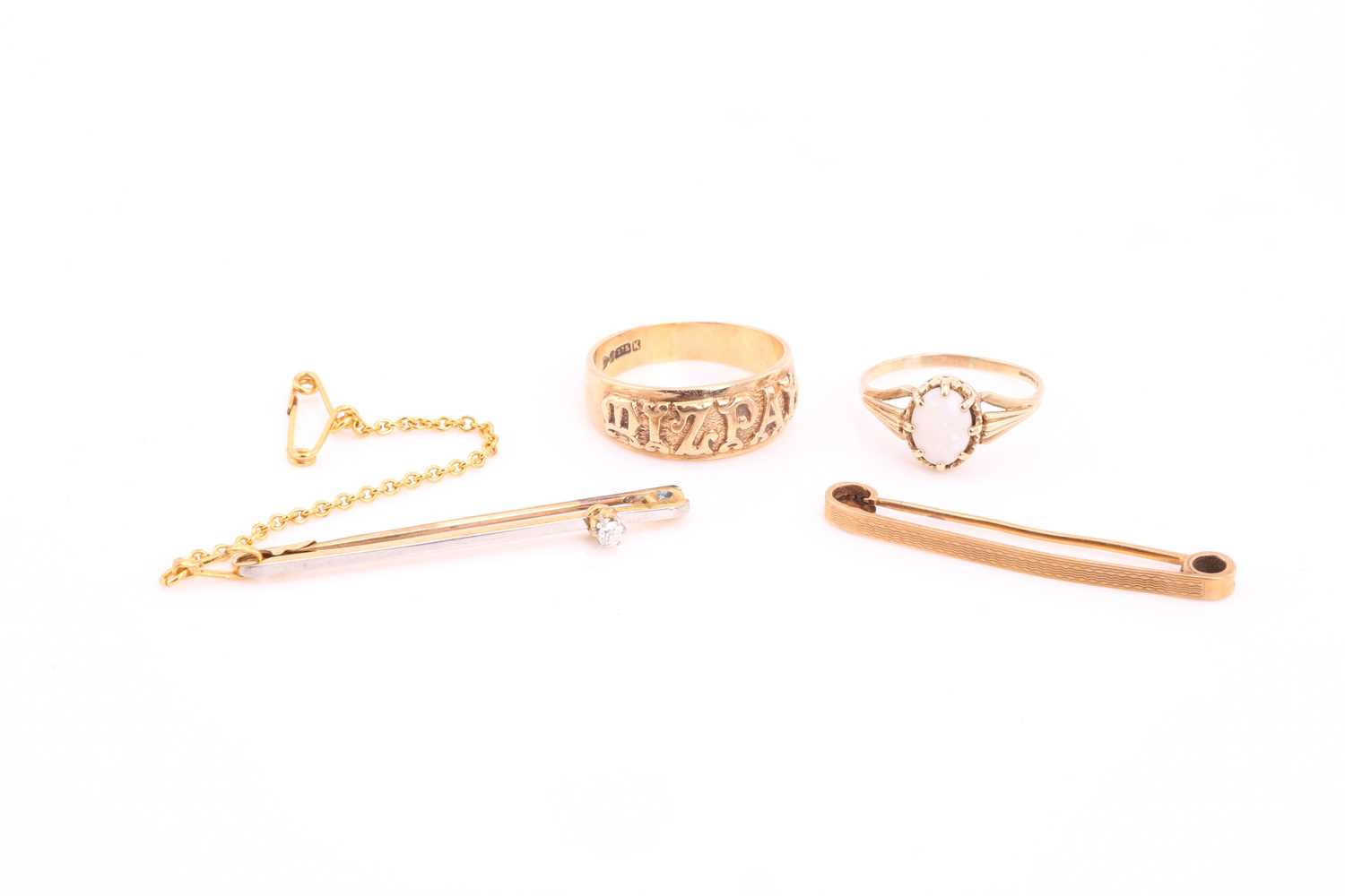 A 9 carat gold Mizpah ring; a single stone opal ring; a single stone diamond bar brooch and an