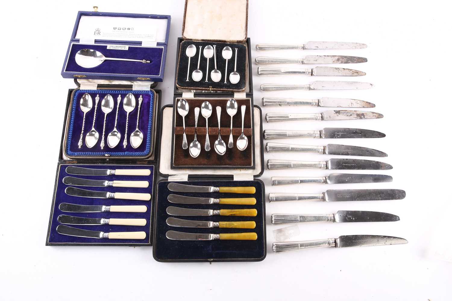 A small collection of cased silver teaspoons and a collection of silver-handled table knives,