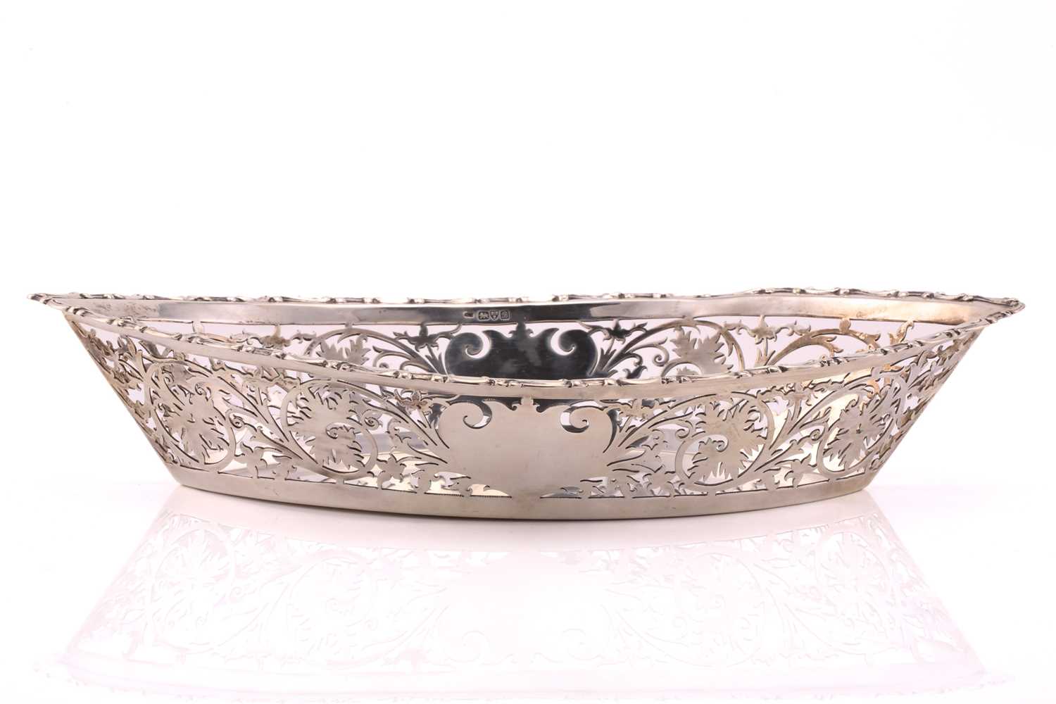 An Edwardian navette form pierced silver breadbasket. Chester 1902 by William Neale. With cast and