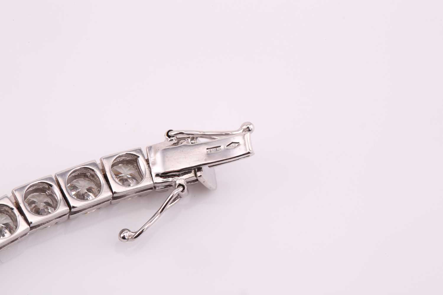 A diamond tennis bracelet, set with thirty-three round brilliant diamonds, each weighing an - Image 10 of 10