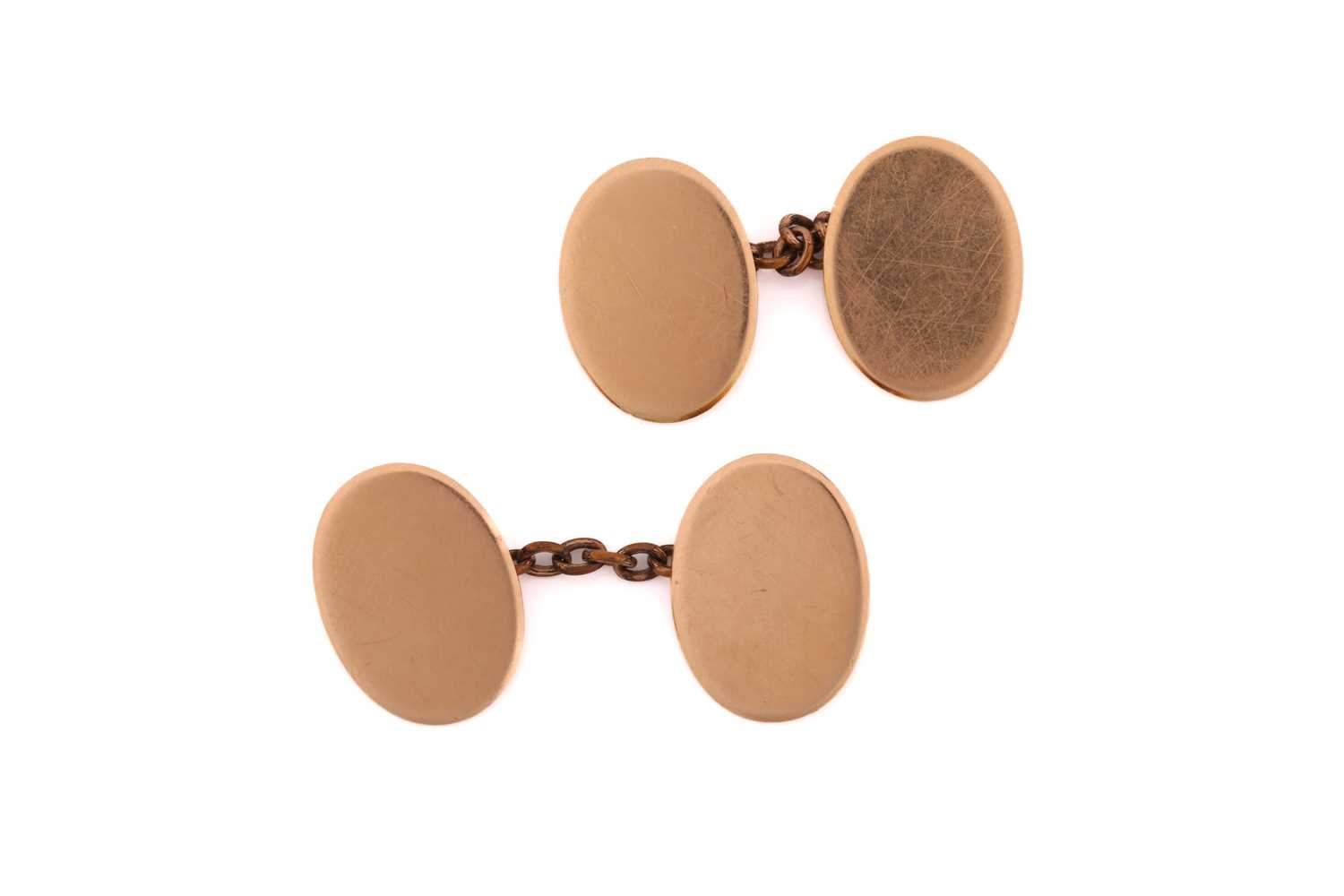 A pair of 15ct gold oval cufflinks, each consisting of plain oval yellow gold panels approximately