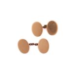 A pair of 15ct gold oval cufflinks, each consisting of plain oval yellow gold panels approximately