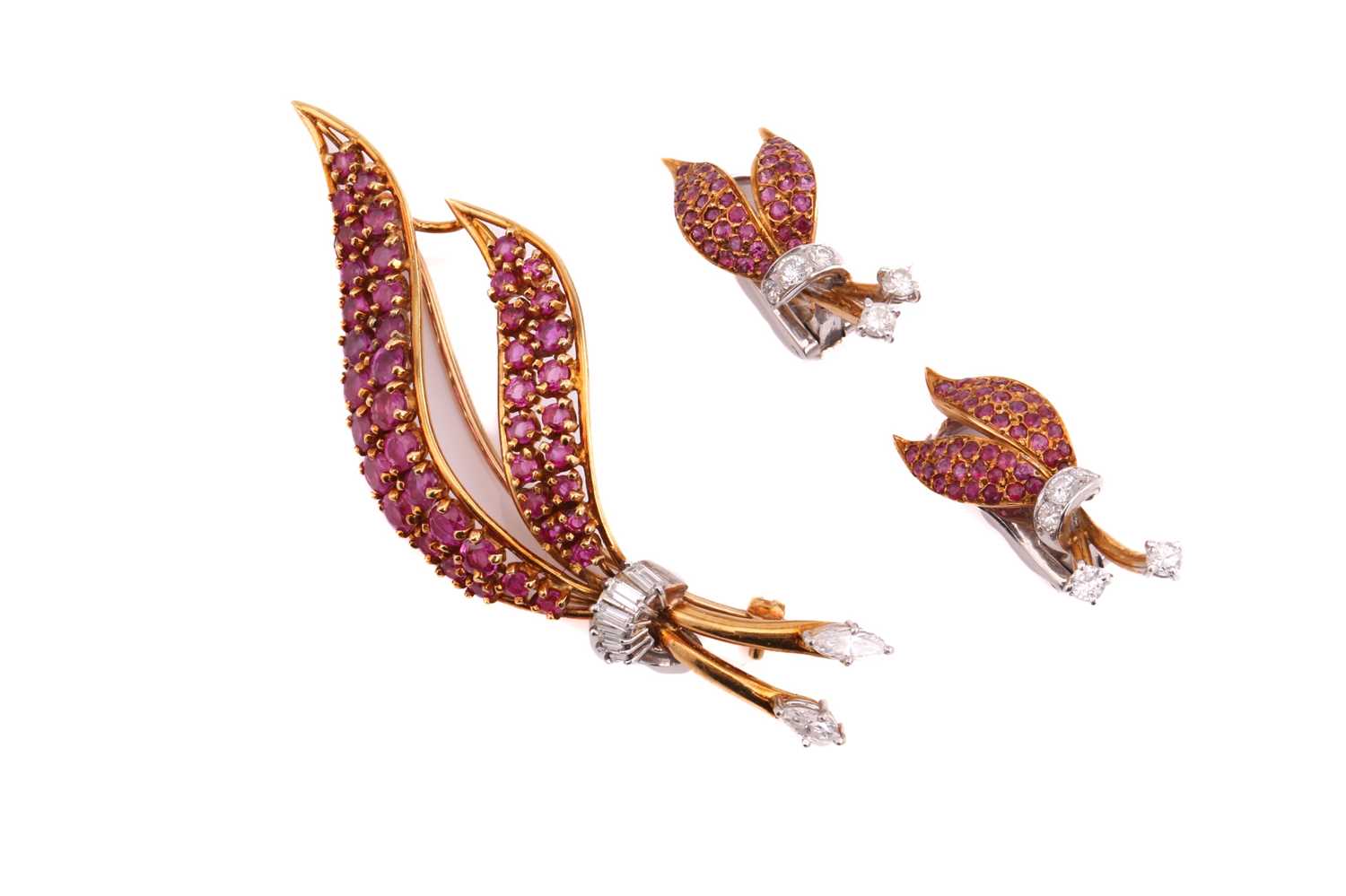 A suite of ruby and diamond brooch with a matching pair of earrings. The floral brooch consists of