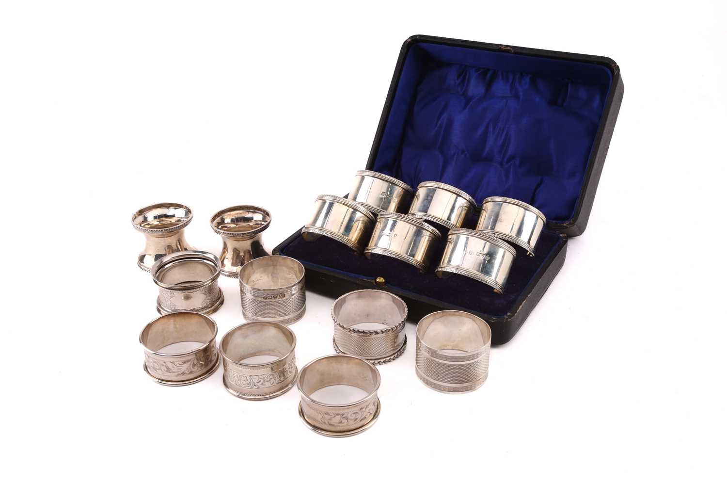 A cased set of six early 20th-century silver napkin rings, Chester 1917 by John & William Deakin.