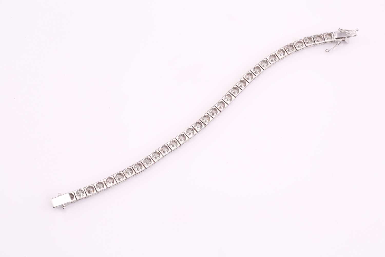 A diamond tennis bracelet, set with thirty-three round brilliant diamonds, each weighing an - Image 3 of 10